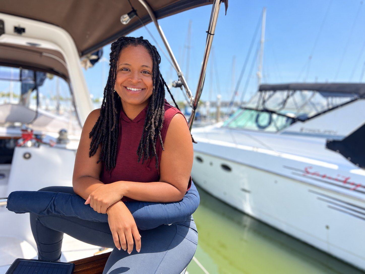 Alia smiling aboard the boat at the marina