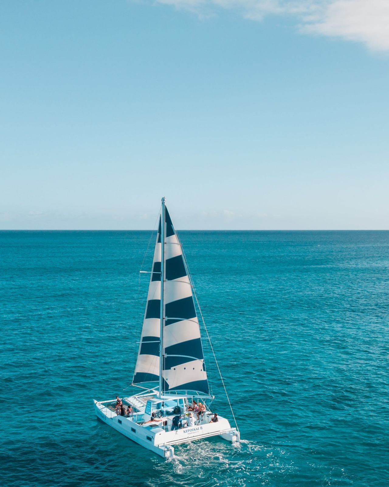 Charter catamaran under sail with guests aboard