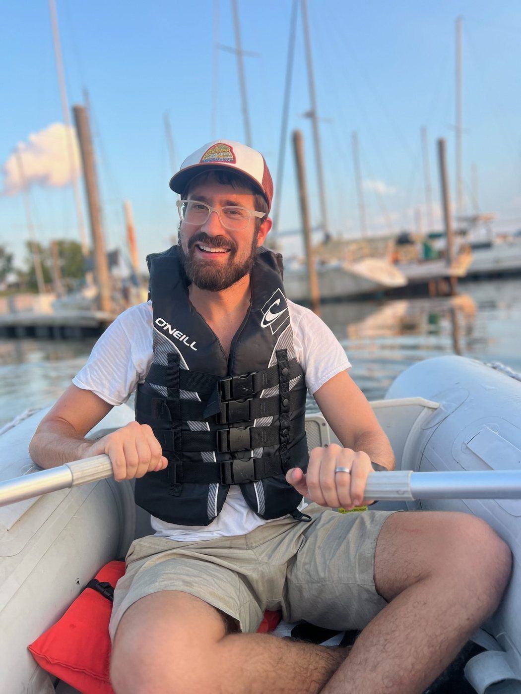 Hayden rowing a dinghy through the marina