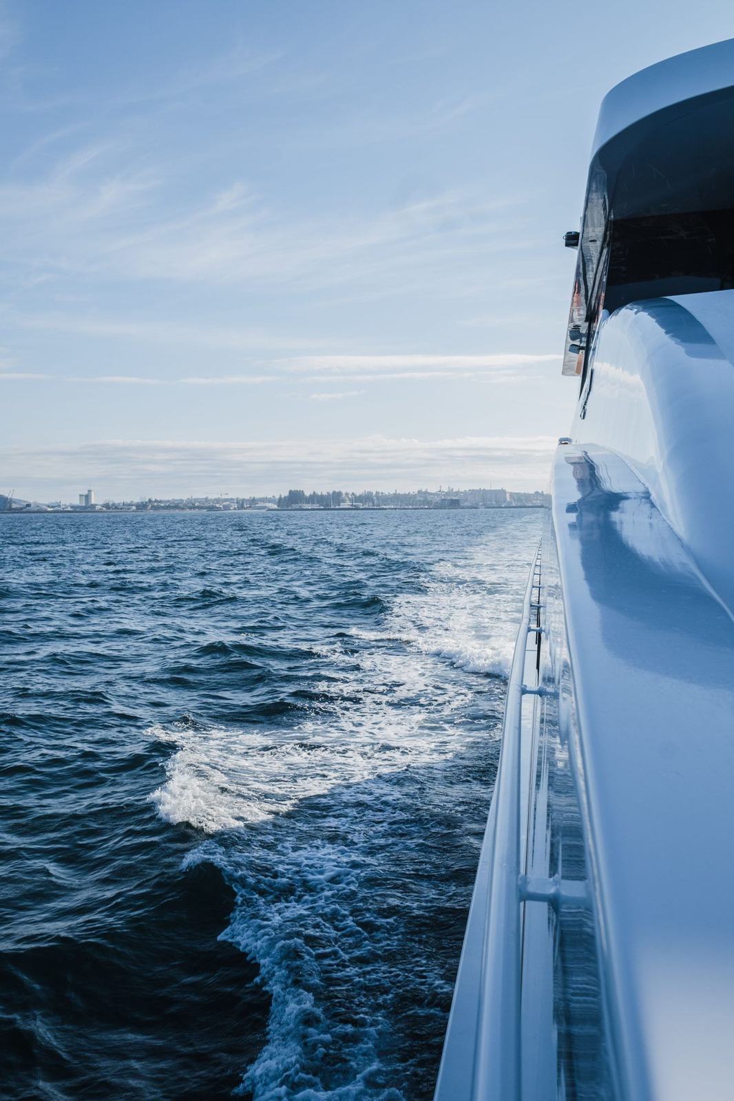 Polished hull of a yacht under way